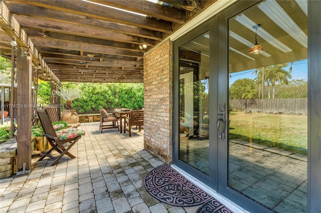 view of patio featuring fence and outdoor dining space