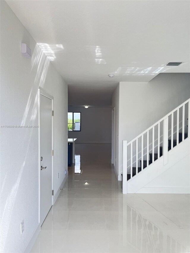15771 SW 136th Ter, Miami, FL 33196 - staircase featuring tile patterned flooring, visible vents, and baseboards