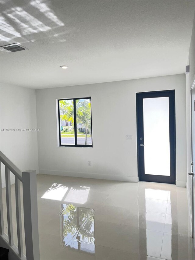 15771 SW 136th Ter, Miami, FL 33196 - unfurnished room with visible vents and a textured ceiling