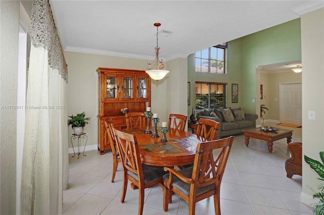 dining space featuring crown molding, visible vents, and light tile patterned floors