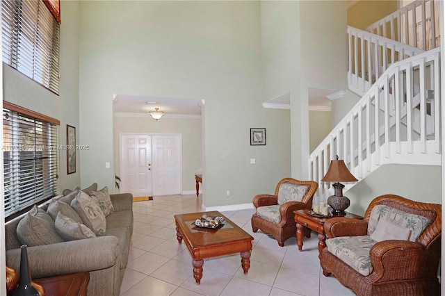 living room featuring baseboards, ornamental molding, tile patterned flooring, and stairs