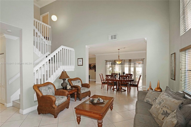 living area featuring ornamental molding, visible vents, stairway, and light tile patterned floors