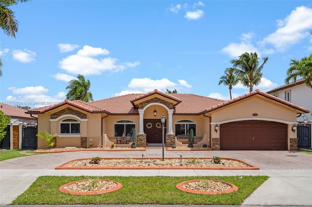 3663 SW 150th Ct, Miami, FL 33185 - mediterranean / spanish-style house featuring decorative driveway, stucco siding, a tile roof, and a garage