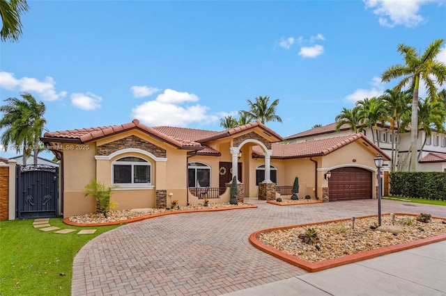 3663 SW 150th Ct, Miami, FL 33185 - mediterranean / spanish home featuring curved driveway, stucco siding, a gate, and a tile roof
