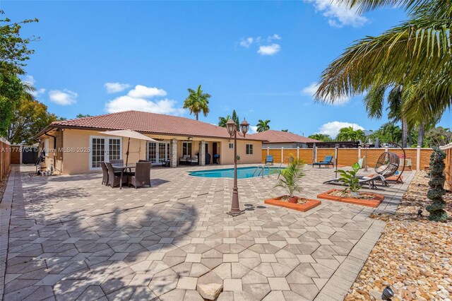 3663 SW 150th Ct, Miami, FL 33185 - view of pool featuring french doors, a fenced backyard, and a patio