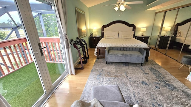 bedroom with light wood-style flooring and lofted ceiling