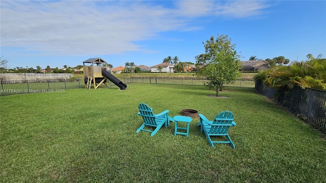 view of yard featuring a fenced backyard and a playground