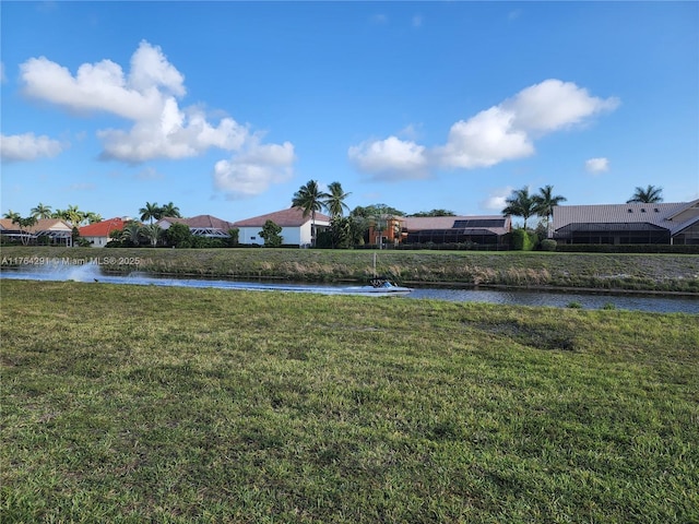 view of yard with a water view and a residential view