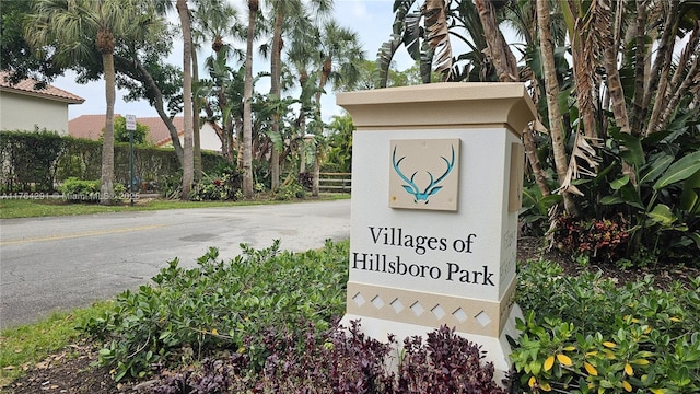 community / neighborhood sign with fence