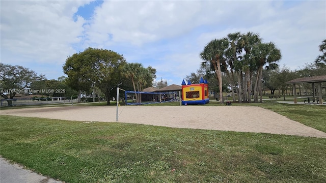view of home's community with playground community, volleyball court, and a lawn