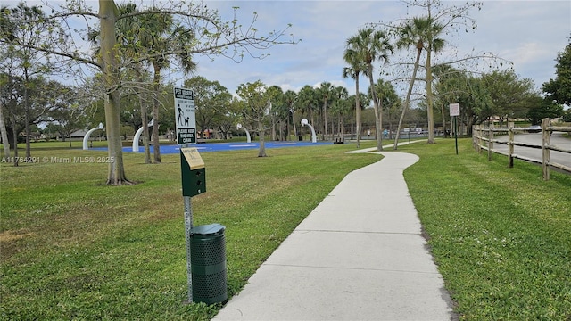 view of home's community with a yard and community basketball court