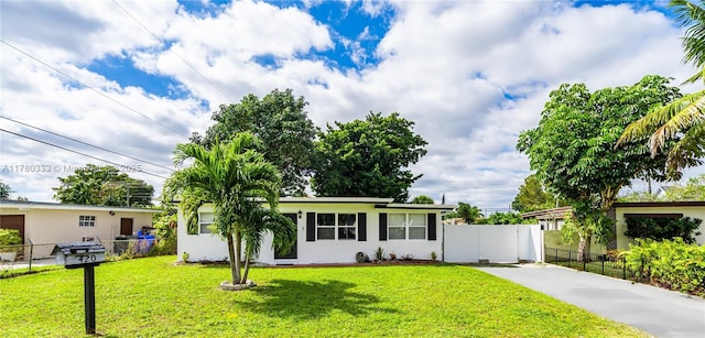420 S 61st Ter, Hollywood, FL 33023 - ranch-style house featuring concrete driveway, a front yard, fence, and stucco siding