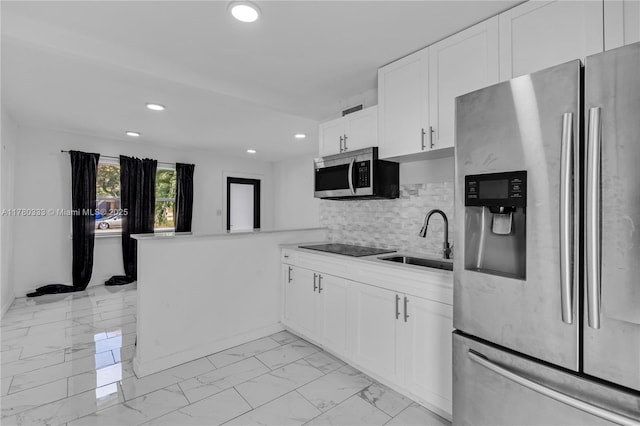 420 S 61st Ter, Hollywood, FL 33023 - kitchen with a sink, appliances with stainless steel finishes, a peninsula, white cabinetry, and marble finish floor
