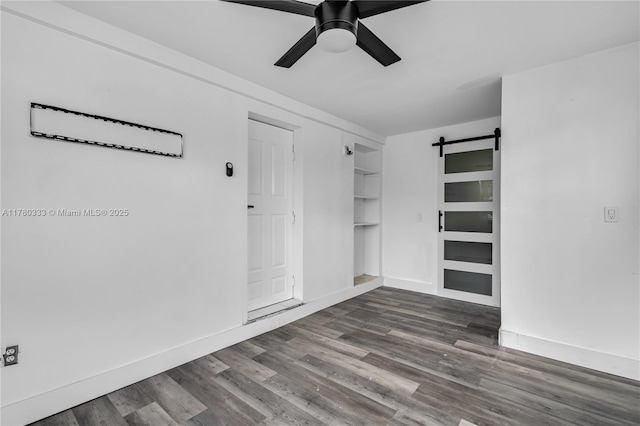 420 S 61st Ter, Hollywood, FL 33023 - interior space featuring ceiling fan, a barn door, wood finished floors, and baseboards