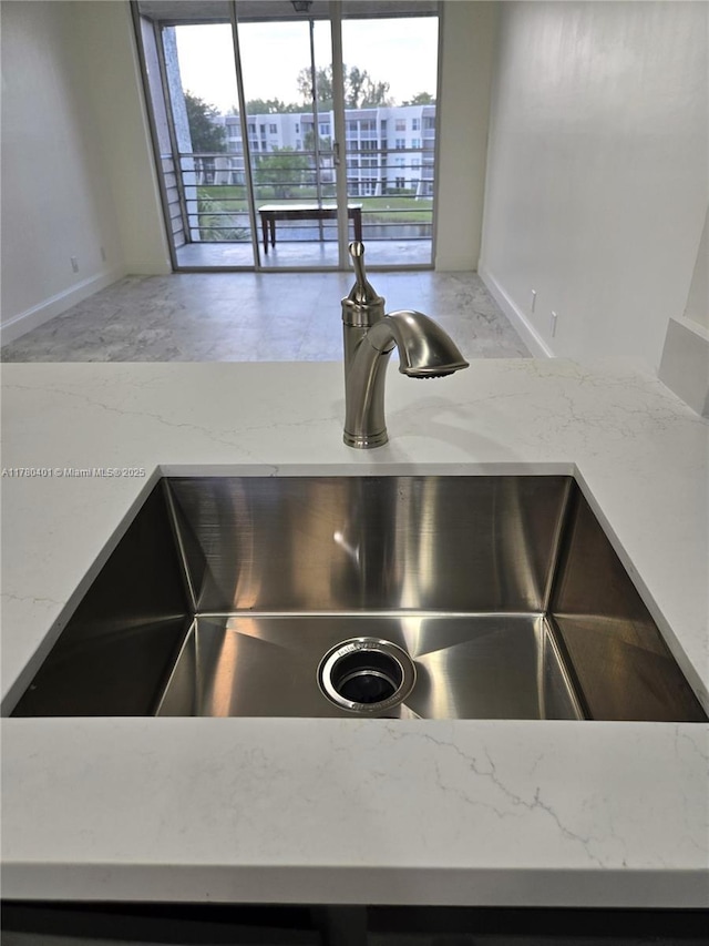 9311 Orange Grove Dr Unit 406, Davie, FL 33324 - room details with baseboards, a sink, and light stone counters