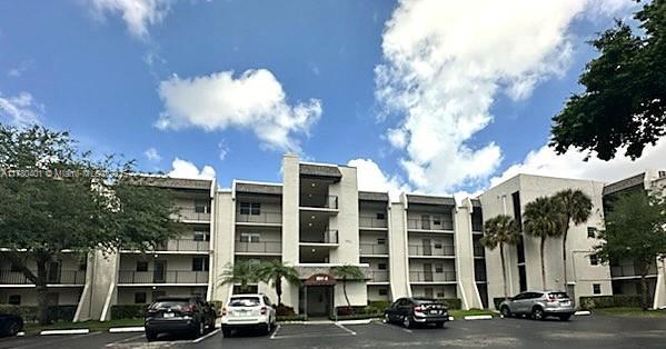 9311 Orange Grove Dr Unit 406, Davie, FL 33324 - view of building exterior featuring uncovered parking