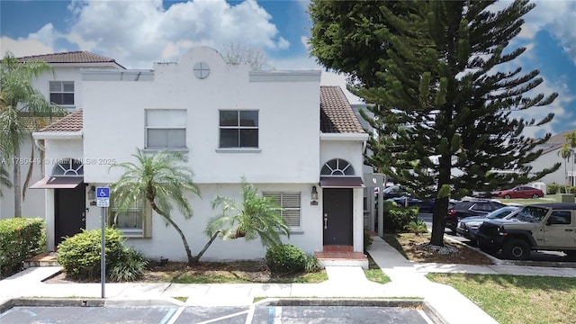 4756 NW 97th Ct Unit 79, Doral, FL 33178 - view of front of property with stucco siding, uncovered parking, and a tile roof