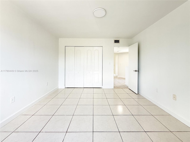 4756 NW 97th Ct Unit 79, Doral, FL 33178 - unfurnished bedroom with a closet, light tile patterned floors, baseboards, and visible vents