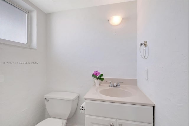 bathroom with toilet and vanity