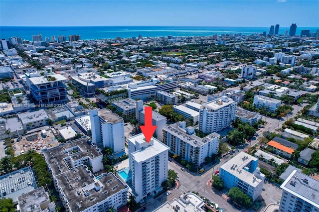 bird's eye view featuring a water view and a city view