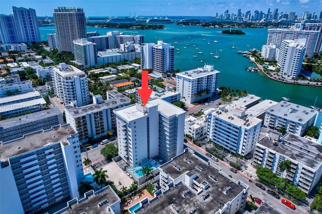 birds eye view of property featuring a view of city and a water view