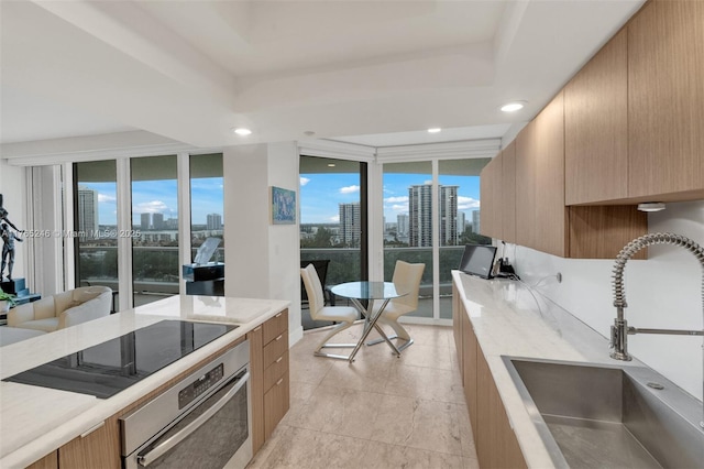 7000 Island Blvd Unit 1208, Aventura, FL 33160 - kitchen with a sink, oven, modern cabinets, a view of skyline, and plenty of natural light
