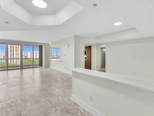 7000 Island Blvd Unit 1208, Aventura, FL 33160 - spare room featuring a tray ceiling and baseboards