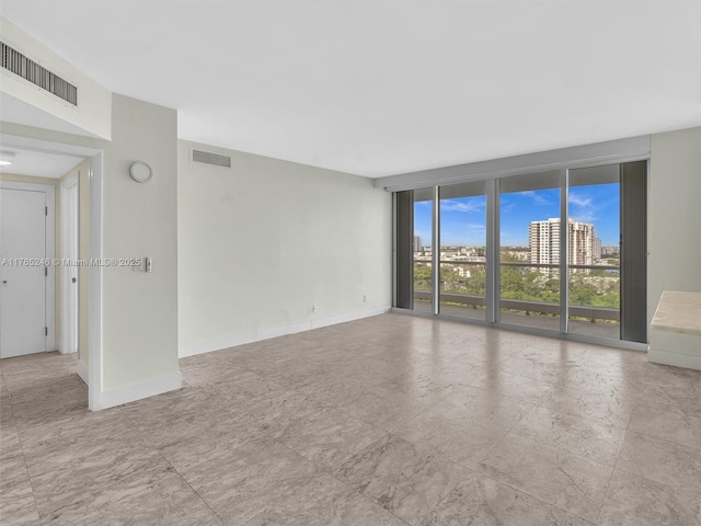 7000 Island Blvd Unit 1208, Aventura, FL 33160 - spare room with baseboards and expansive windows