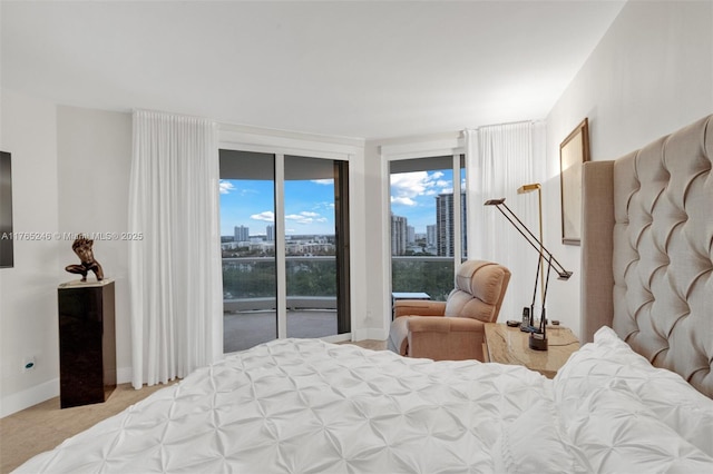 7000 Island Blvd Unit 1208, Aventura, FL 33160 - carpeted bedroom featuring access to exterior, a view of skyline, and baseboards
