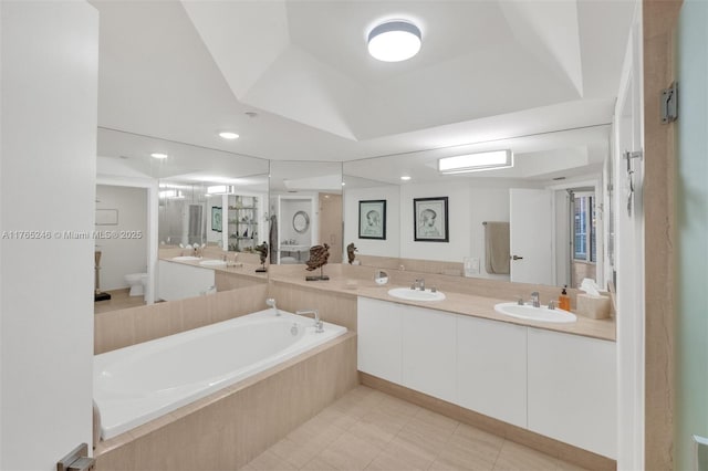 7000 Island Blvd Unit 1208, Aventura, FL 33160 - bathroom featuring double vanity, toilet, a garden tub, recessed lighting, and tile patterned floors