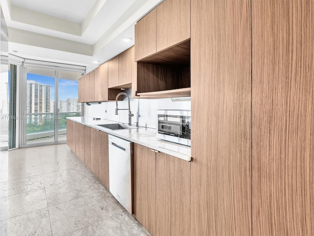 7000 Island Blvd Unit 1208, Aventura, FL 33160 - kitchen with stainless steel microwave, dishwasher, light countertops, modern cabinets, and light brown cabinetry
