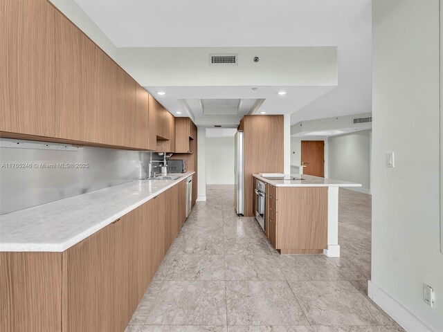 7000 Island Blvd Unit 1208, Aventura, FL 33160 - kitchen with modern cabinets, light countertops, stainless steel oven, recessed lighting, and a tray ceiling