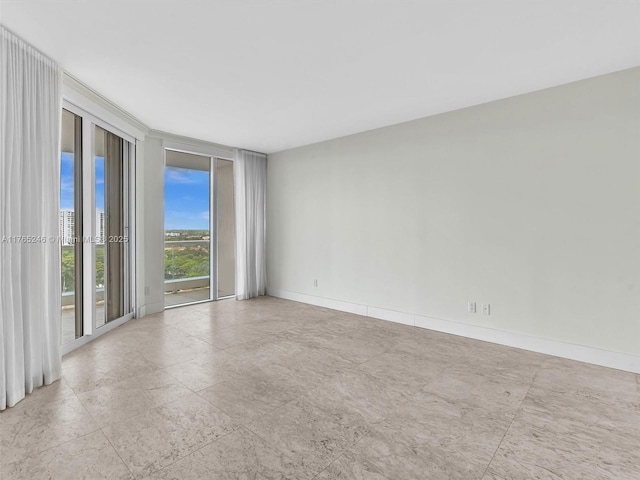 7000 Island Blvd Unit 1208, Aventura, FL 33160 - spare room featuring a wall of windows and baseboards
