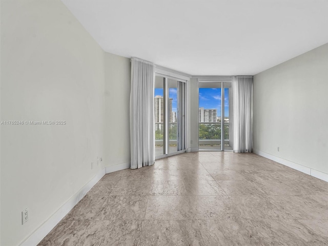 7000 Island Blvd Unit 1208, Aventura, FL 33160 - empty room with floor to ceiling windows and a city view