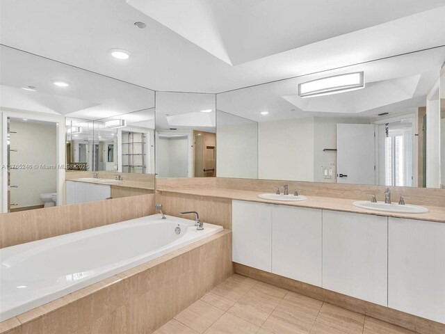 7000 Island Blvd Unit 1208, Aventura, FL 33160 - bathroom with double vanity, a bath, and tile patterned flooring