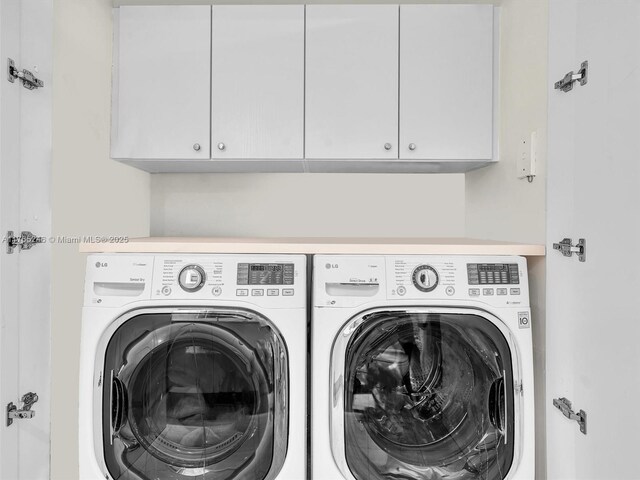 7000 Island Blvd Unit 1208, Aventura, FL 33160 - laundry area featuring washer and clothes dryer and cabinet space
