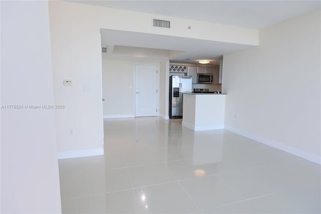 interior space featuring visible vents, baseboards, and light tile patterned floors