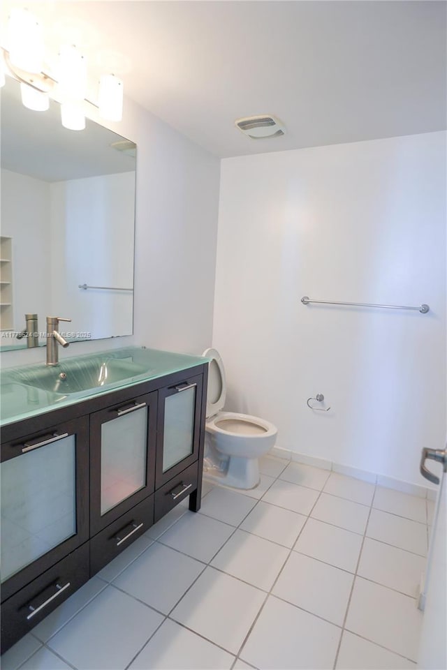 bathroom featuring tile patterned flooring, vanity, visible vents, and toilet