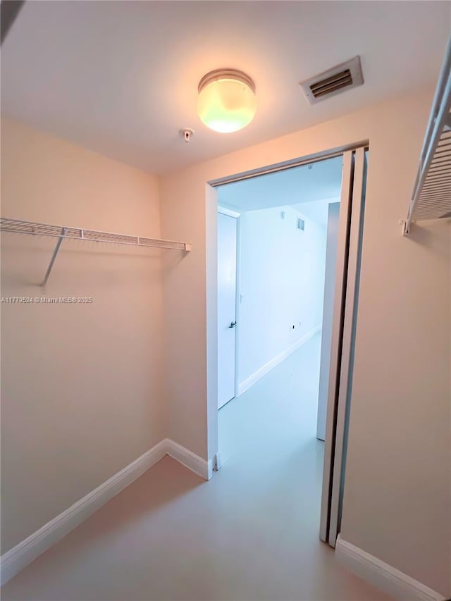 spacious closet featuring visible vents