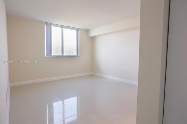 tiled empty room with baseboards