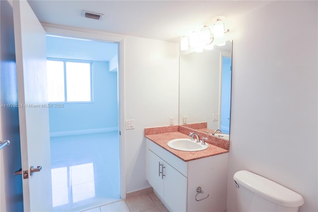 bathroom featuring toilet, tile patterned floors, vanity, and visible vents