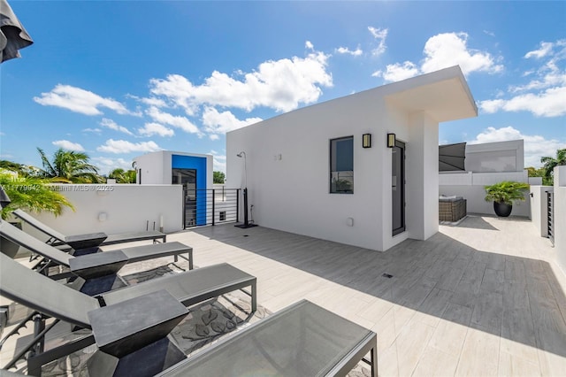 2679 NE 8th Ave, Wilton Manors, FL 33334 - kitchen featuring stainless steel fridge, modern cabinets, wall chimney range hood, a sink, and white cabinetry
