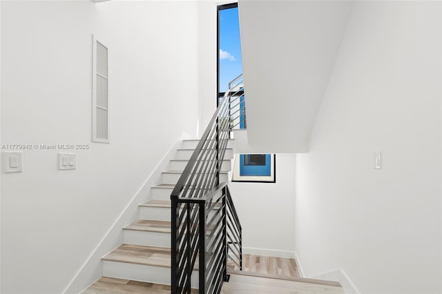 2679 NE 8th Ave, Wilton Manors, FL 33334 - stairway featuring baseboards and wood finished floors