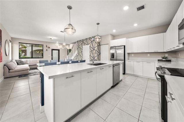 4641 NW 83rd Pkwy Unit 4641, Doral, FL 33166 - kitchen featuring visible vents, light tile patterned floors, open floor plan, light countertops, and appliances with stainless steel finishes