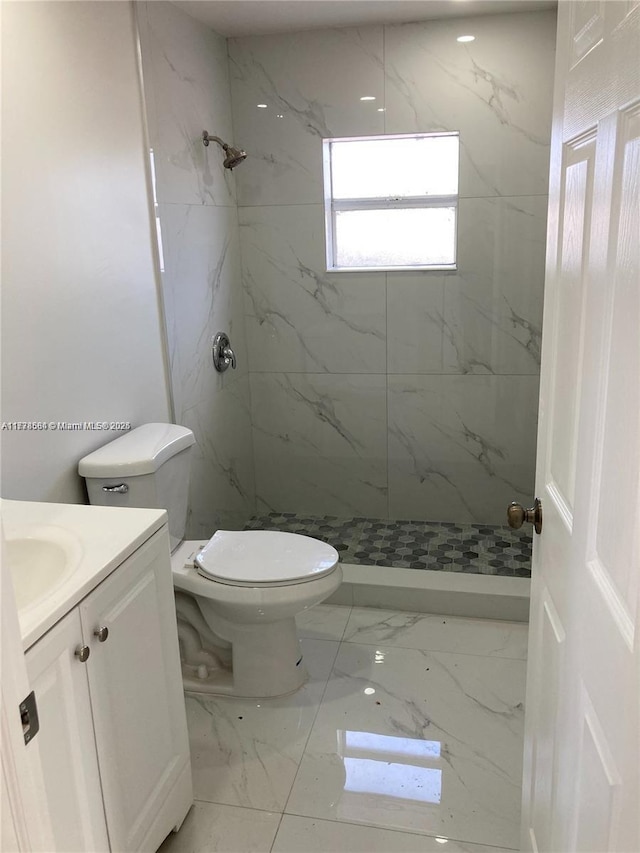 bathroom with toilet, marble finish floor, and a marble finish shower