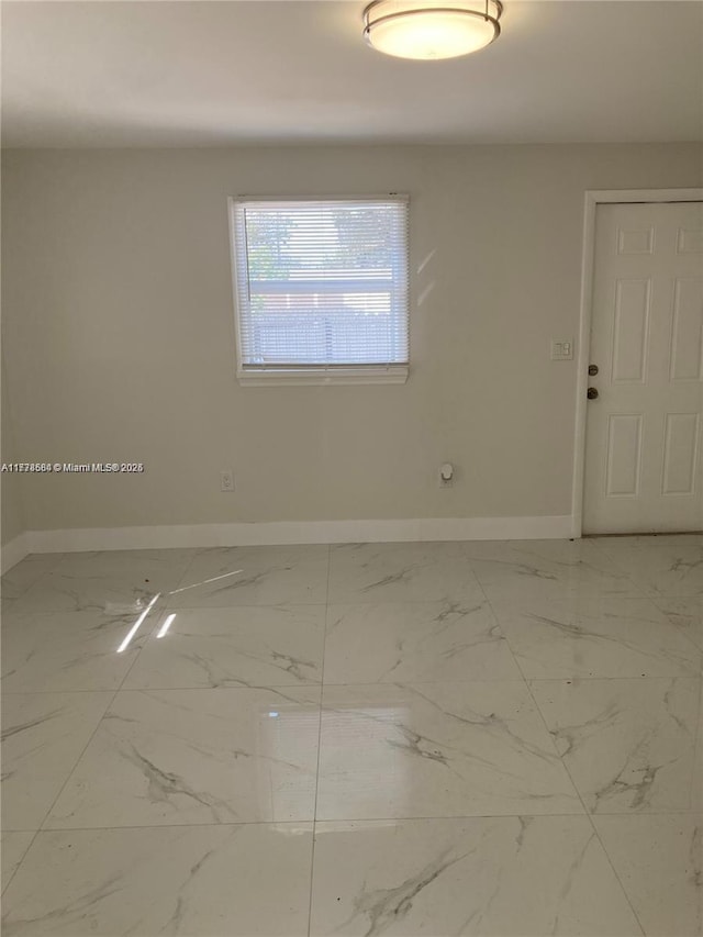 empty room with marble finish floor and baseboards