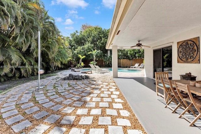 view of patio / terrace with ceiling fan, a fenced in pool, and a fenced backyard