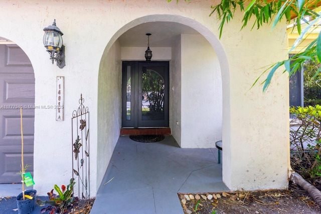 doorway to property with stucco siding