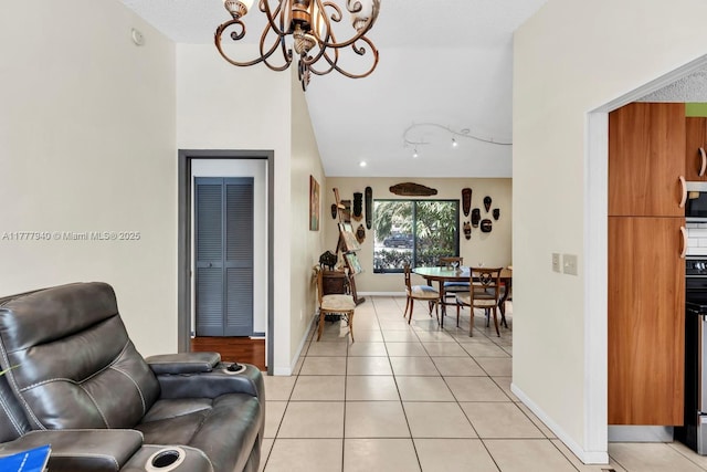 interior space featuring light tile patterned floors, baseboards, and a notable chandelier