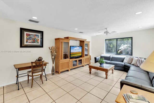 living area featuring light tile patterned flooring, a ceiling fan, baseboards, recessed lighting, and visible vents